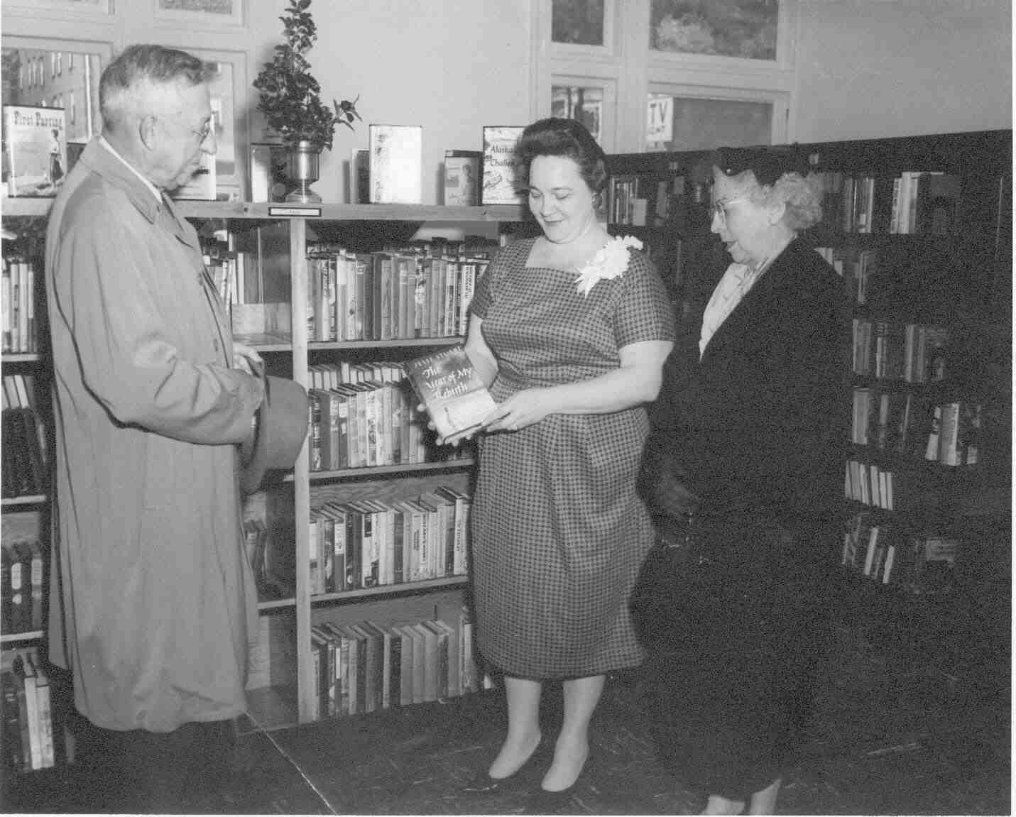 Mr. and Mrs. Milton Crisp presenting book to Library Director Mrs. Robinson at May 5, 1955 dedication
